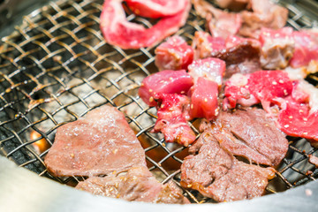 Japanese style Raw fresh beef on hot barbecue grill .