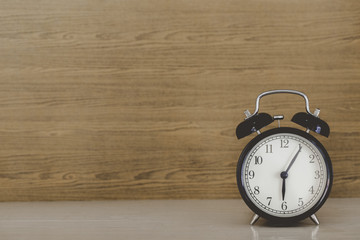 alarm clock on wood table, vintage style