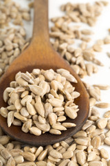 Shelled sunflower seeds in wooden spoon