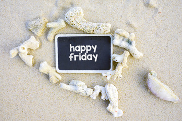 HAPPY FRIDAY text written on chalkboard, on beach.