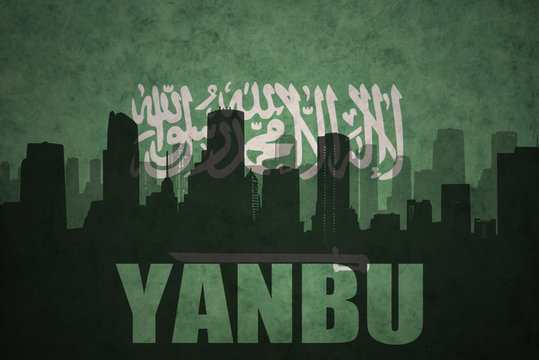 abstract silhouette of the city with text Yanbu at the vintage saudi arabia flag background