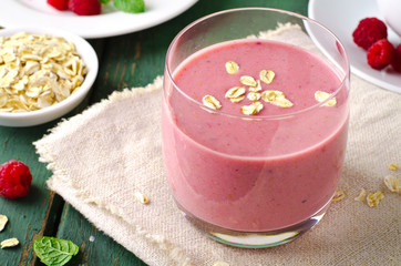 Obraz na płótnie Canvas Healthy berry with raspberry, oatmeal and mint in a glass