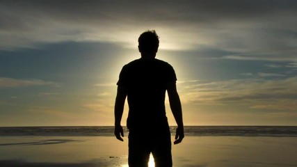 Model released person walking out on sandy beach shoreline to catch some rays, enjoy the breeze and relax at the Pacific Coast in Oregon. - Powered by Adobe