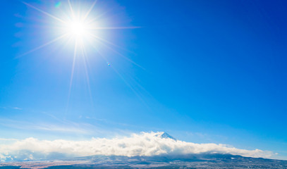 Naklejka na ściany i meble Mountain Fuji with blue sky and sun, Japan