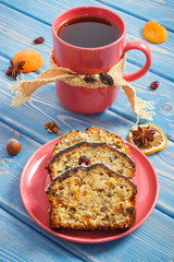 Cup of tea and fresh baked fruitcake on plate