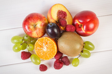 Fresh ripe fruits on white boards, healthy nutrition