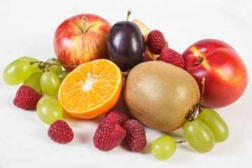 Fresh ripe fruits on white boards, healthy nutrition