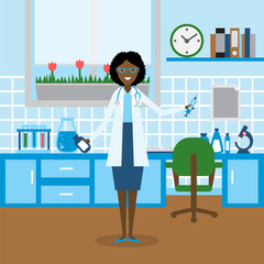 Doctor in the lab. Funny smiling african american female doctor or scientist in the medical lab. Chemistry cabinet.