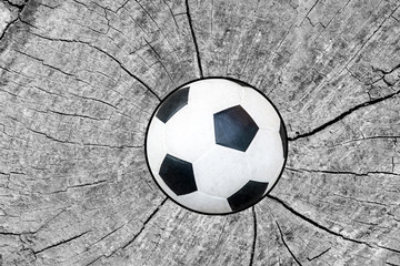 soccer ball coming in cracked wood wall