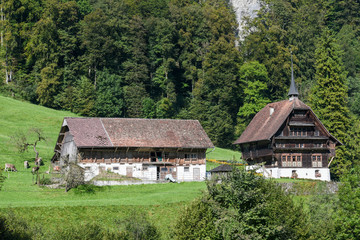 Plakat Rural view of a farm with beautiful house at Wolfenschiessen