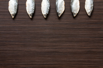 Dried roach on the dark brown background - good snack to beer