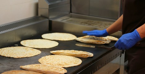 experienced cook with latex gloves cooking Italian specialty cal