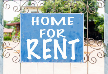 Fototapeta premium Chalkboard sign in front of house for rent