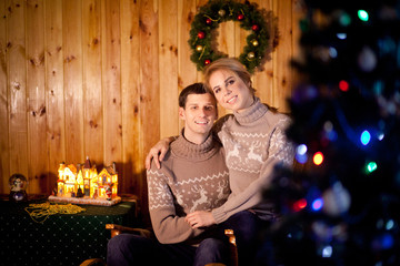 A couple or husband and wife in a house decorated in anticipation of the New Year or Christmas
