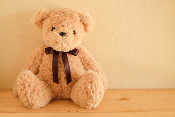 Teddy Bear toy alone on wooden table