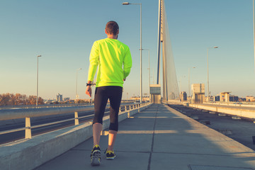 Urban jogger on the bridge.