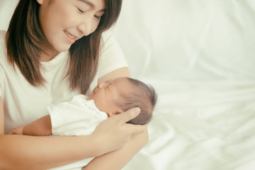 Happy asian mother holding adorable child baby boy., soft color,