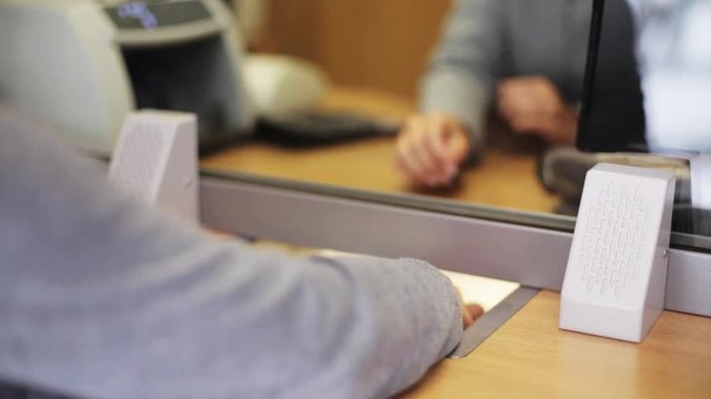clerk counting money and customer at bank office