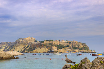 Fototapeta na wymiar Gargano National Park:Tremiti Island (Apulia) ITALY. A view of San Nicola island from the nearby San Domino island, with the Abbey of Santa Maria a Mare fortified complex.