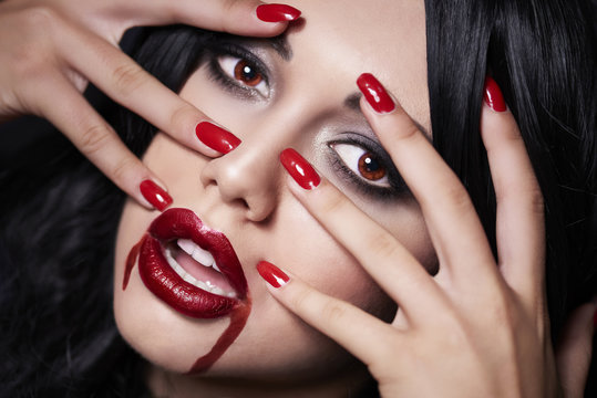 Beautiful vampire face with her fingers