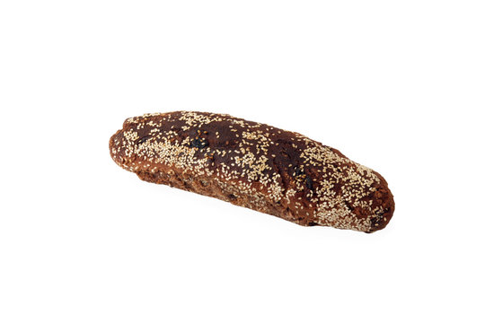 Loaf of rye unleavened  bread sprinkled sesame isolated on white
