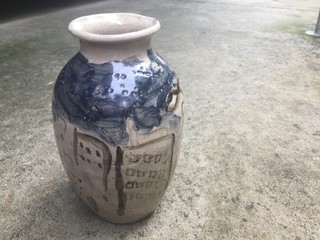 Antique jar on cement background