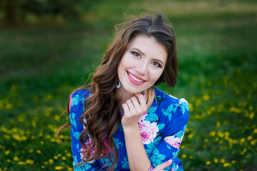 Portrait of young woman rest in the park smiling on the grass