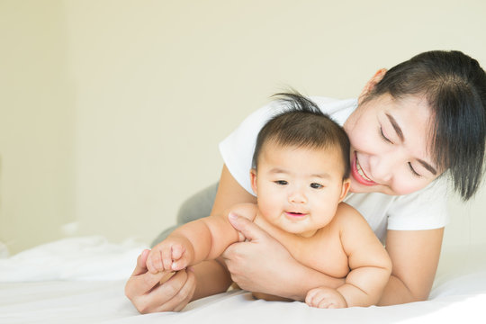 happy family.asian Mother and baby playing and smiling under a b