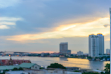 Blurred Cityscape of Bangkok with Chao Phraya river at evening time