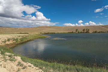 lake steppe sky clouds mountains