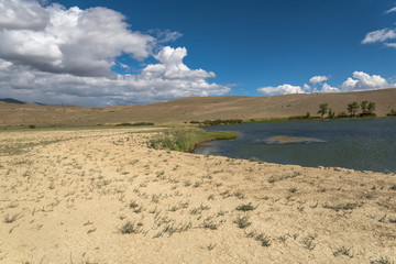 lake steppe sky clouds mountains