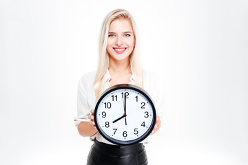 Smiling businesswoman holding big clock