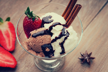 Ice cream sundae and sliced strawberry 
