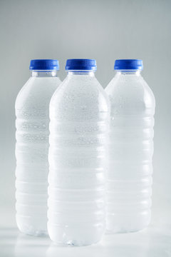 Wet plastic water bottles isolated on white background