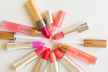 pile of wet coloful lipsticks on wooden table