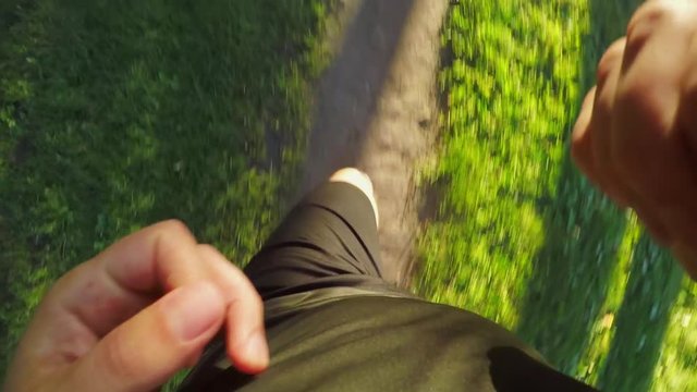 TOP VIEW: Man runs on a forest path (slow motion)