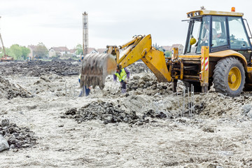 Workers are working manually next to the excavator, teamwork, ma
