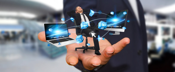 Man on his chair at the office connected to modern devices