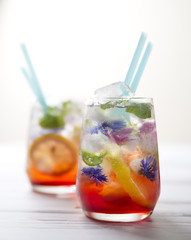 Refreshing summer drink with lemon and flower