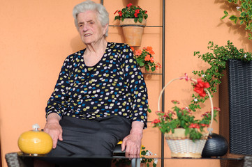 Happy senior woman sitting outside and smiling