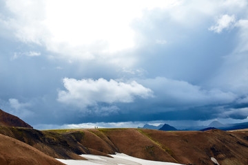 Obraz premium Travel to Iceland. Beautiful Icelandic landscape with mountains, sky and clouds. Trekking in national park Landmannalaugar