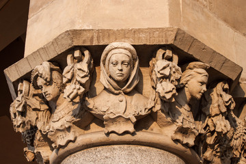 Capital of a column of the Cloth Hall (Sukiennice) decorated by polish artist Jan Matejko. Busts of  polish noble women. Krakow, Poland.
