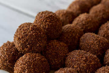 Dark ball shaped sweets. Lots of brown candies. Traditional russian dessert. Butter and crumbled biscuits.