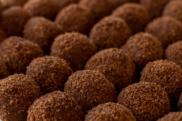 Sweets of brown color. Ball shaped candies. Tasty dessert from russian cuisine. Crumbled cookies and butter,