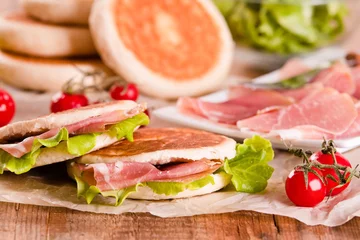 Foto op Plexiglas Tigella bread stuffed with ham and lettuce. © Mi.Ti.