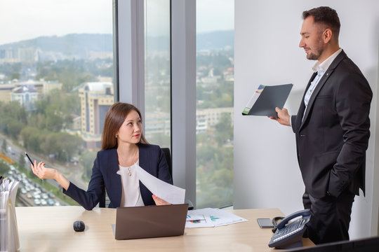 Businessman brought the report to his colleague young Asian girls
