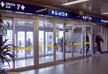airport terminal, exit gate, people walking
