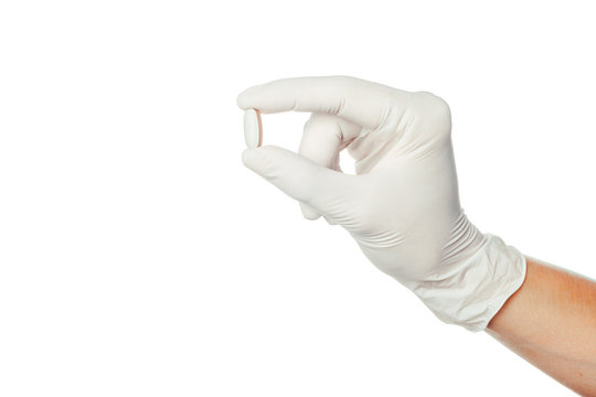 Doctor's Hand In White Sterilized Surgical Glove Holding Medicine