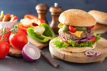 homemade cheese burger with peppers tomato onion
