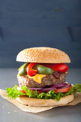 homemade cheese burger with peppers tomato onion
